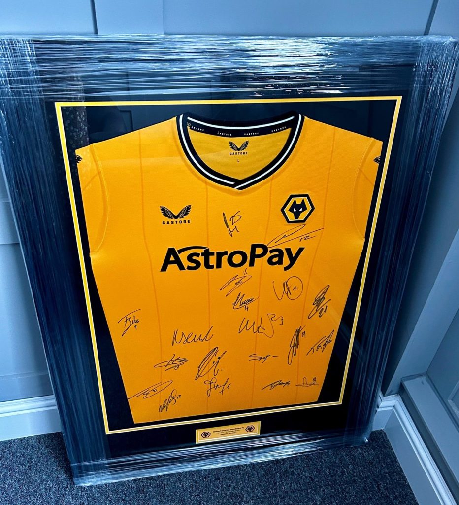 Photo of a signed Wolverhampton Wanderers football shirt in a frame